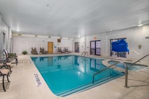 a large swimming pool with blue water in a building at Best Western Plus Shamrock Inn & Suites in Shamrock