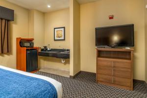 a hotel room with a sink and a flat screen tv at Best Western Plus Shamrock Inn & Suites in Shamrock