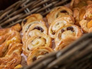 a bunch of pastries sitting in a basket at Garner Hotel Rotherham East by IHG in Rotherham