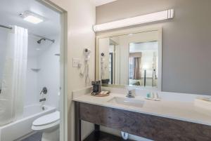a bathroom with a sink and a toilet and a mirror at Quality Inn & Suites Conference Center Thomasville in Thomasville +29 photos