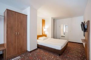 En eller flere senger på et rom på Quality Hotel Erlangen Garni