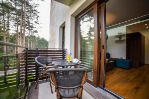 a balcony with a small table and chairs on it at Apartmani Buket Zlatibor in Zlatibor