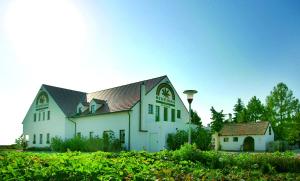 a large white building with a black roof at Hanfthal-Hof in Laa an der Thaya