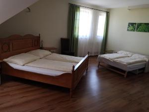 a bedroom with two beds and a window at Hanfthal-Hof in Laa an der Thaya