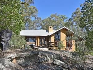 a house in the middle of a forest at Corymbia in Broke