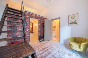 a living room with a staircase and a chair at Design Apartments -Innenstadt in Potsdam