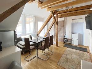 a kitchen and dining room with a table and chairs at Schwanenburg Apartments in Panketal