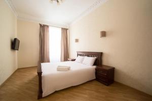 a bedroom with a large white bed with a window at Apartment on Virmenska 3, with 2 separate bedrooms in Lviv