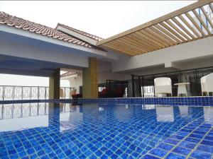 a swimming pool with blue tiles in a building at The Cube Malioboro Hotel in Yogyakarta