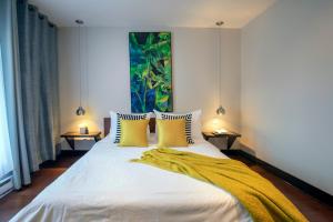 a bedroom with a large white bed with yellow pillows at Lofts Jacques-Cartier Free Parking in Montreal