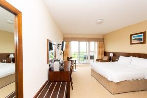 Ένα ή περισσότερα κρεβάτια σε δωμάτιο στο Strandhill Lodge and Suites Boutique Hotel