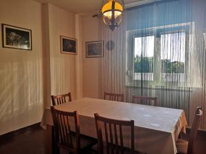 a dining room with a white table and chairs at Apartment Valentin in Ugljan