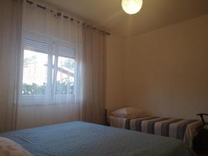 a bedroom with two beds and a window at Apartment Valentin in Ugljan