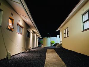 an empty alleyway between two buildings at night at River Valley Guest House in Butterworth