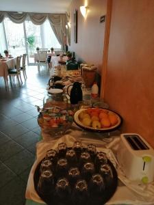 - une table avec un bouquet de petits gâteaux et d'autres aliments dans l'établissement Hotel De La Tour, à Pont-de-lʼArche