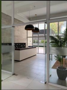 a lobby of a building with a potted plant at Depto Estoril Clinica Las Condes in Santiago