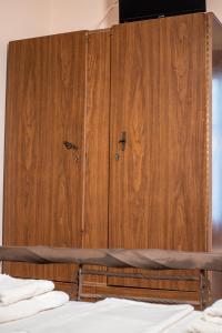 a wooden cabinet in a kitchen with a wooden floor at Lamprou in Kosmas
