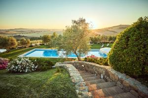an image of a garden with a swimming pool at Podere Lamino in Monticchiello