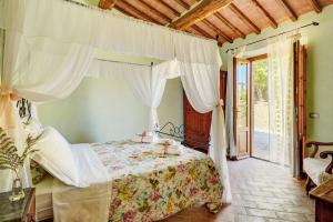 a bedroom with a bed with a canopy at Podere Lamino in Monticchiello