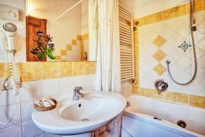 a bathroom with a sink and a shower and a tub at Podere Lamino in Monticchiello +28 photos