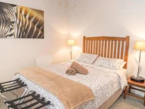 a bedroom with a bed and a picture of a zebra at New Beginnings Cottage in Montagu