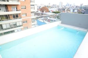 a swimming pool on the balcony of a building at Montañeses 2830 Modern Flat in Buenos Aires