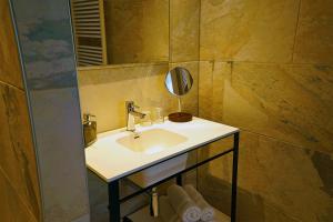 a bathroom with a sink and a mirror at Abdij Hotel Rolduc in Kerkrade