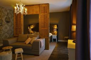 a living room with a couch and a bedroom at Abdij Hotel Rolduc in Kerkrade
