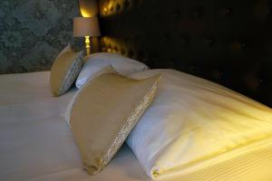 a bed with two pillows and a lamp on it at Abdij Hotel Rolduc in Kerkrade