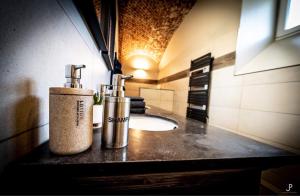 a bathroom with two bottles on a counter at La Belle Étable in Dinant
