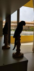 two statues of birds are sitting on a table at PLAYA LAS VISTAS LOFT in Los Cristianos