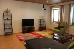 a living room with a couch and a television at Apartmán Domčeková in Košice