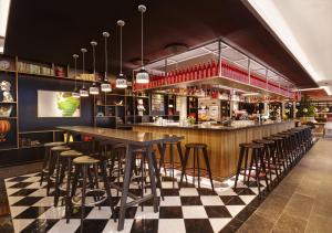 a bar with black and white checkered floor at citizenM Copenhagen Radhuspladsen in Copenhagen