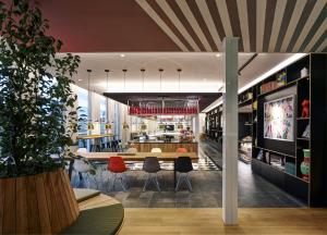 a dining room and kitchen with a table and chairs at citizenM Copenhagen Radhuspladsen in Copenhagen