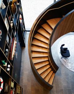 a spiral staircase in a store with an apple sign on it at citizenM Rotterdam in Rotterdam