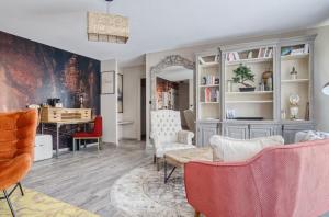 a living room with a table and chairs at La Maison Hôtel Mulhouse Centre in Mulhouse