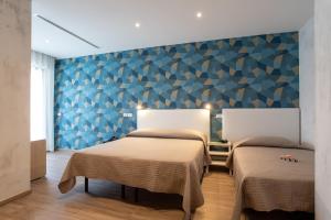 Postel nebo postele na pokoji v ubytování Hotel Rosa