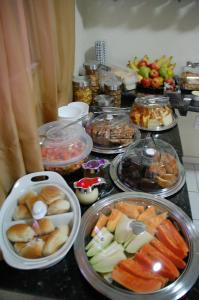 a table topped with trays of different types of food at Netuno Beach Hotel in Fortaleza