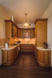 a large kitchen with wooden cabinets and wooden floors at Premium Apartment Old Arbat in Moscow