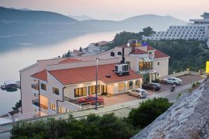 a house on a hill with a view of the water at Hotel Adria in Neum