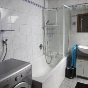 a bathroom with a shower and a tub and a sink at Wohlfühlapartment Erlenberg in Thurmansbang
