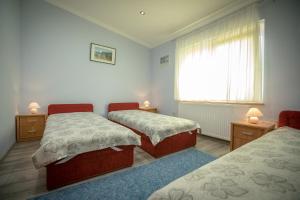 A bed or beds in a room at Orgona Vendégház