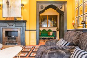 a living room with a couch and a fireplace at Bedford Swan Hotel and Thermal Spa in Bedford