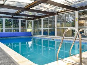 a swimming pool with a ceiling and windows at Tan y Gaer in Aberystwyth