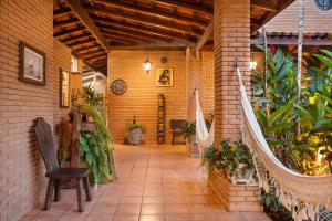 a patio with plants and a chair in a building at Giprita Wellness Hotel Ubatuba in Ubatuba