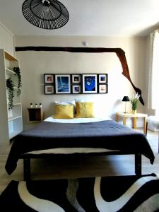 ein Schlafzimmer mit einem großen Bett mit einem großen Kopfteil aus Holz in der Unterkunft Suites Rive Gauche - DUPLEX CHARME Fontainebleau in Fontainebleau