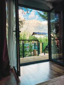 a sliding glass door with a view of a balcony at Moon Montana Busteni in Buşteni