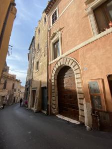 a large brick building with an archway on a street at La Corte Segreta Tivoli in Tivoli