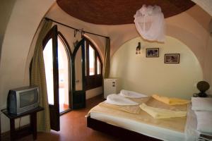 a bedroom with a bed and a tv at Sharks Bay Umbi Diving Village in Sharm El Sheikh