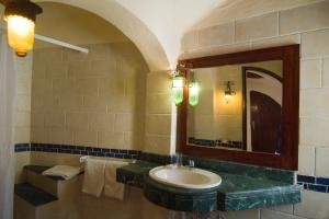 a bathroom with a sink, toilet and mirror at Sharks Bay Umbi Diving Village in Sharm El Sheikh